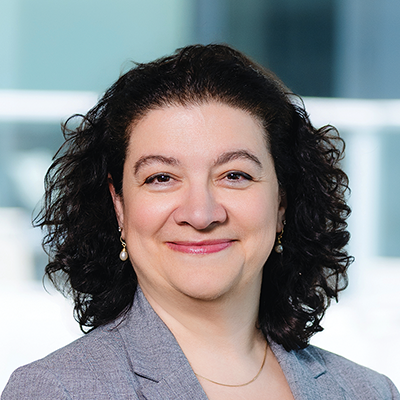 Headshot of Vasiliki Everett smiling at the camera.