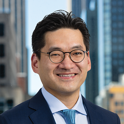 Headshot of Sam Kwon smiling at the camera.