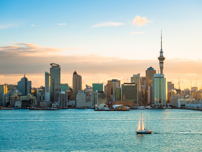 Skyline view of the buildings in Auckland, New Zealand along the water before sunset.