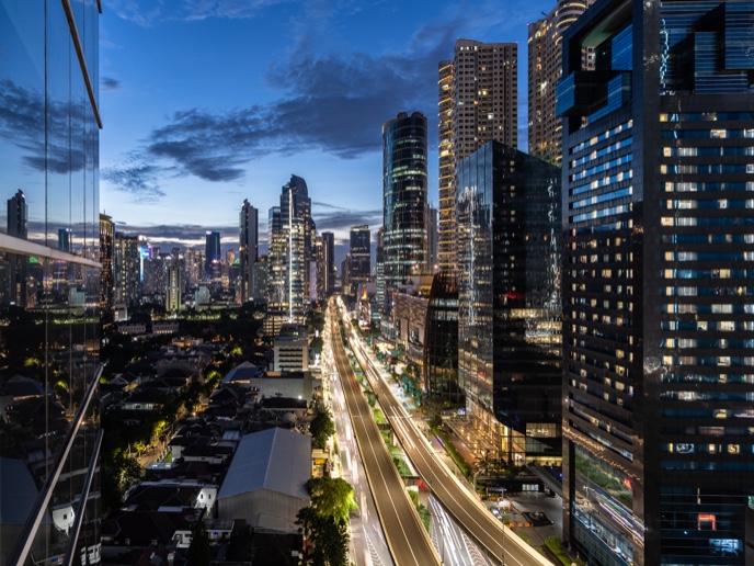 A busy business district in Jakarta, Indonesia at twilight.