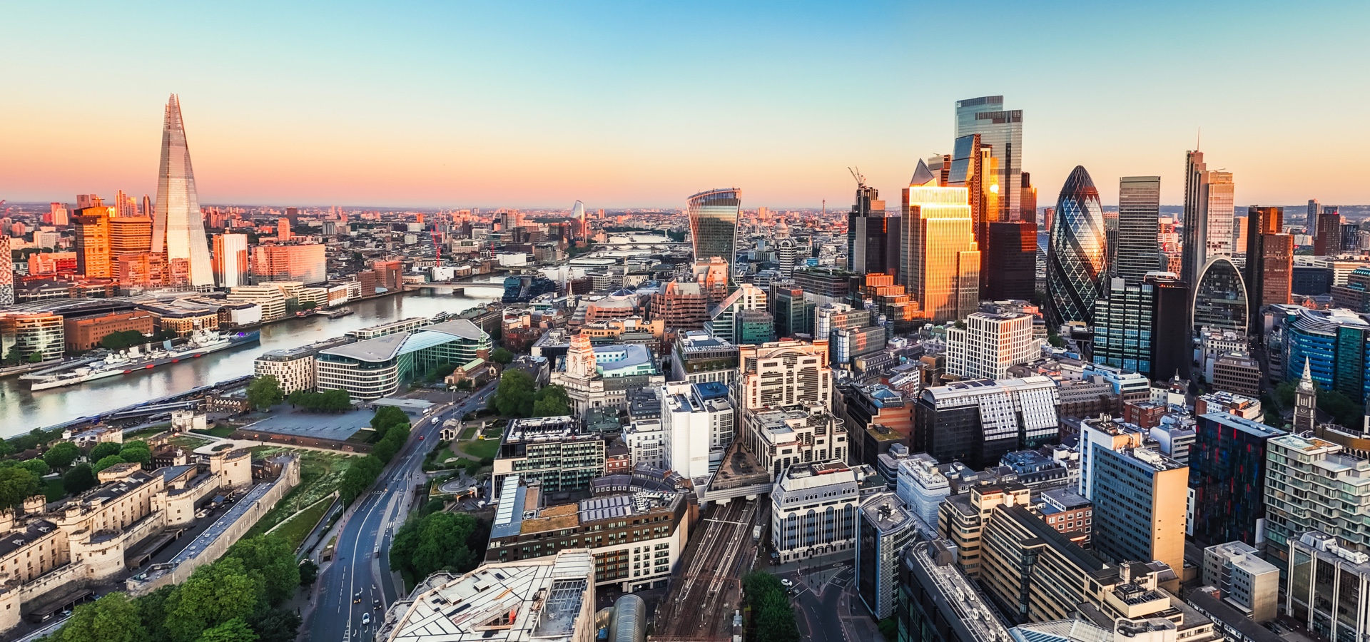 Aerial view of the finance district in London at sunset.