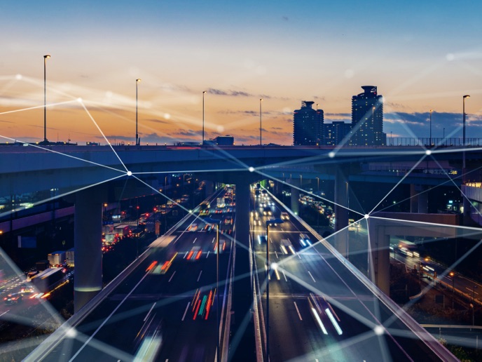 Cityscape overlayed with abstract digital connectivity lines.