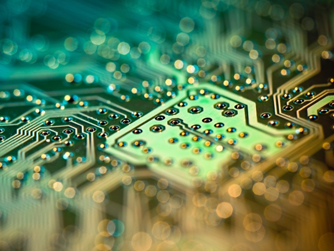 Abstract computer chip with green and yellow color accents.