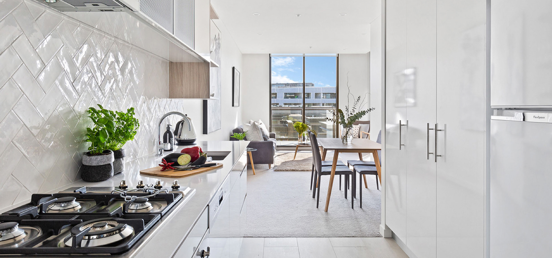 A kitchen with a table and chairs.